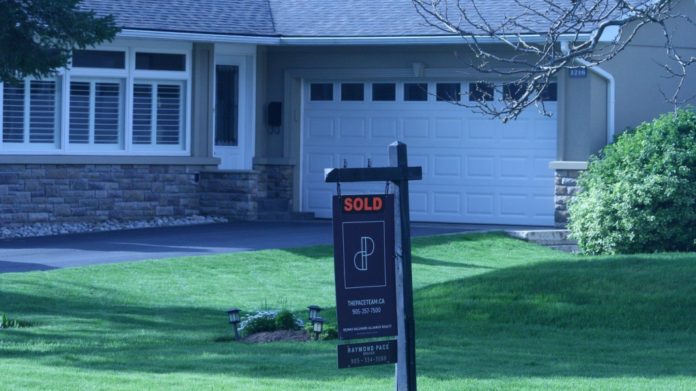 Real estate signage is shown in Oakville, Ont., west of Toronto on Saturday, May 11, 2024. THE CANADIAN PRESS/Richard Buchan