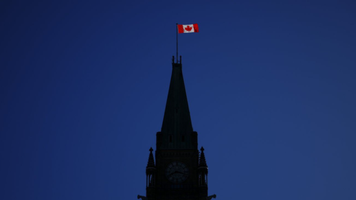 The Canadian flag catches the morning light on the Peace Tower on Parliament Hill in Ottawa on Tuesday, April 16, 2024. THE CANADIAN PRESS/Sean Kilpatrick